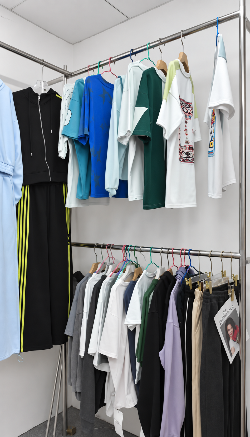 Racks of T-shirts, jackets and other garment samples in the HUAJUN sample room
